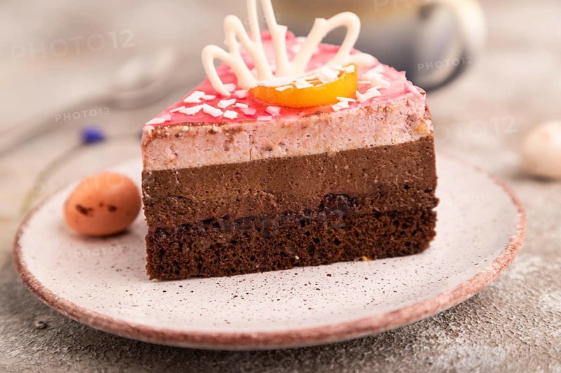 Chocolate cake on brown concrete background, cup of coffee, side view, close up, selective focus