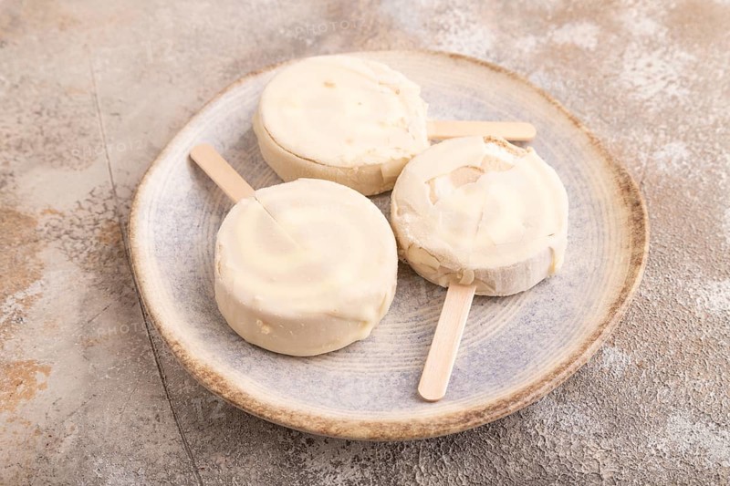 ?hocolate Ice cream in white glaze, on brown concrete background, side view, close up, minimalism