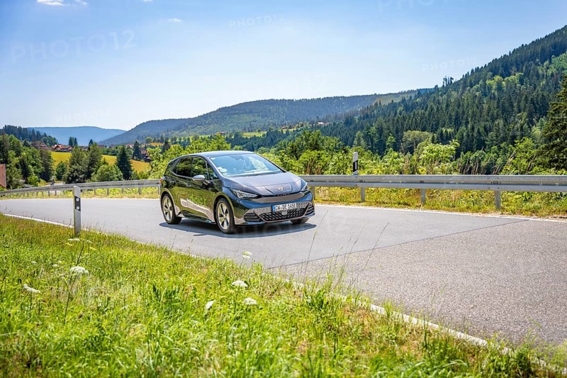 Car driving on a winding road in a mountainous landscape, Deer E-car sharing, Cupra electric car, Germany
