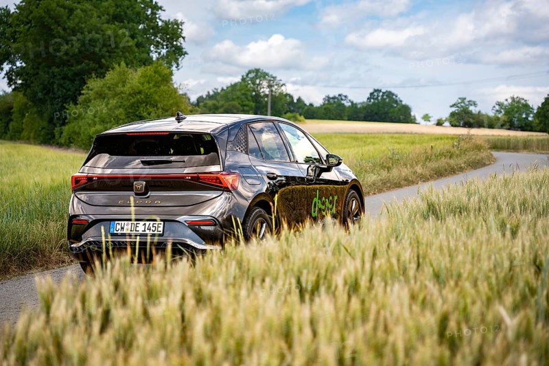 Car on a dirt road surrounded by high fields and cloudy sky, Deer E-car sharing, Cupra electric car, Germany