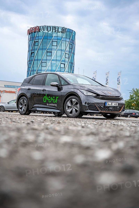 Car in front of a modern tower in a parking lot, deer e-car sharing, Cupra electric car, Böblingen, Germany