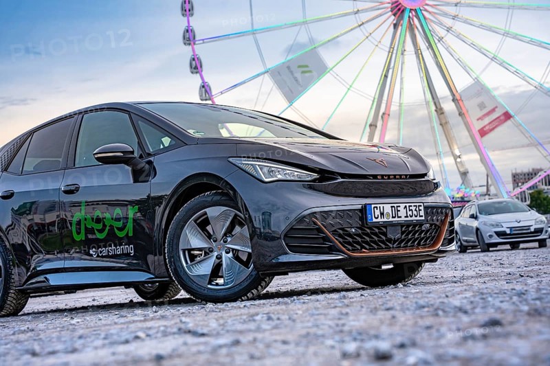 Modern cars in front of a big Ferris wheel at a trade show, Deer E-Car Sharing, Cupra electric car, Germany