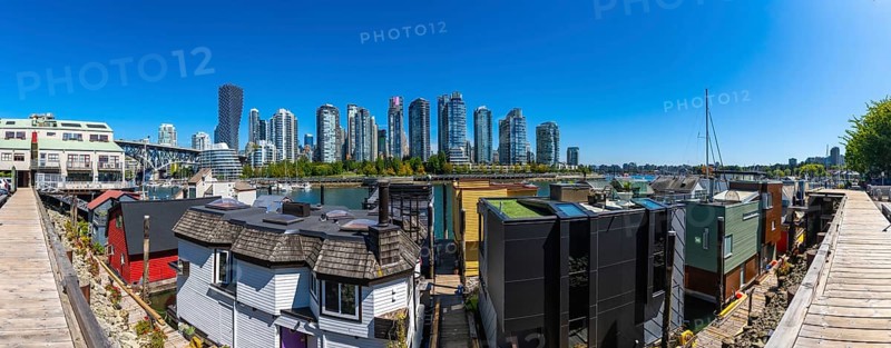 Panoramic view of colorful floating homes in false creek with modern and historical buildings of vancouver in the background, british columbia, canada