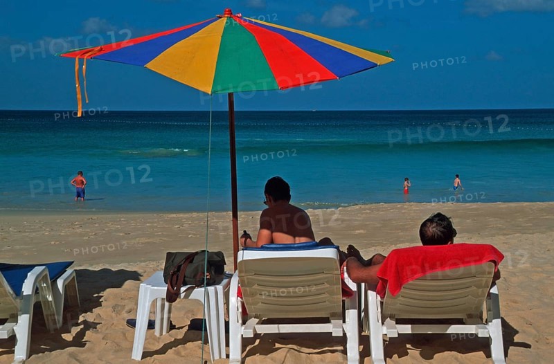 People holding umbrellas and sun loungers on Karon Beach, two years in front of the tsunami, Ko Phuket, Thailand, December 2002, vintage, retro, old, historic