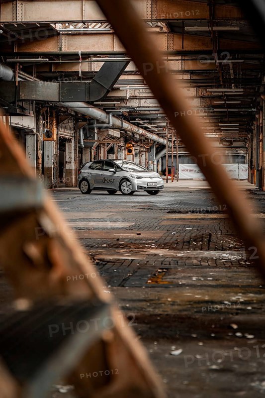 A car is parked in an abandoned factory building that exudes a rusty, mysterious charm, Deer E-Car Sharing, Motorworld Rüsselsheim, Germany