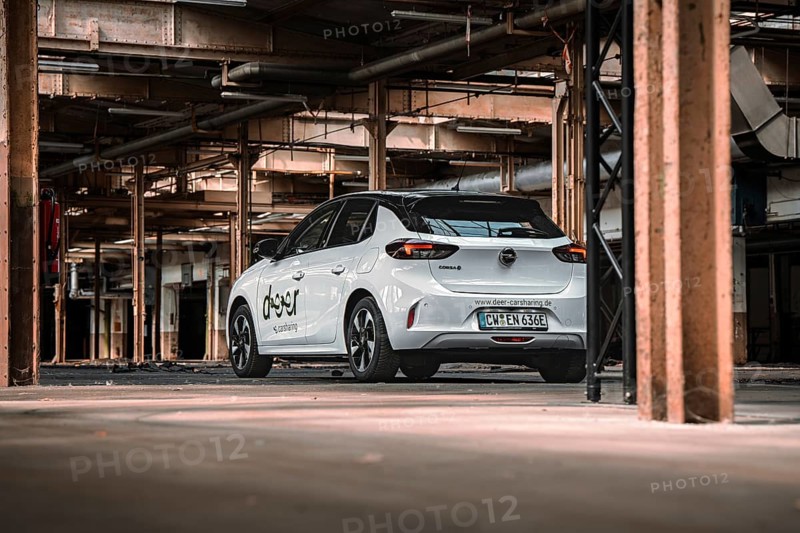 Rear view of a white car sharing car in an urban industrial building, Deer E-Car Sharing, Motorworld Rüsselsheim, Germany