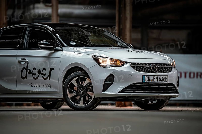 Close up view of a white Opel car sharing car with focus on headlights, Deer E-Car Sharing, Motorworld Rüsselsheim, Germany