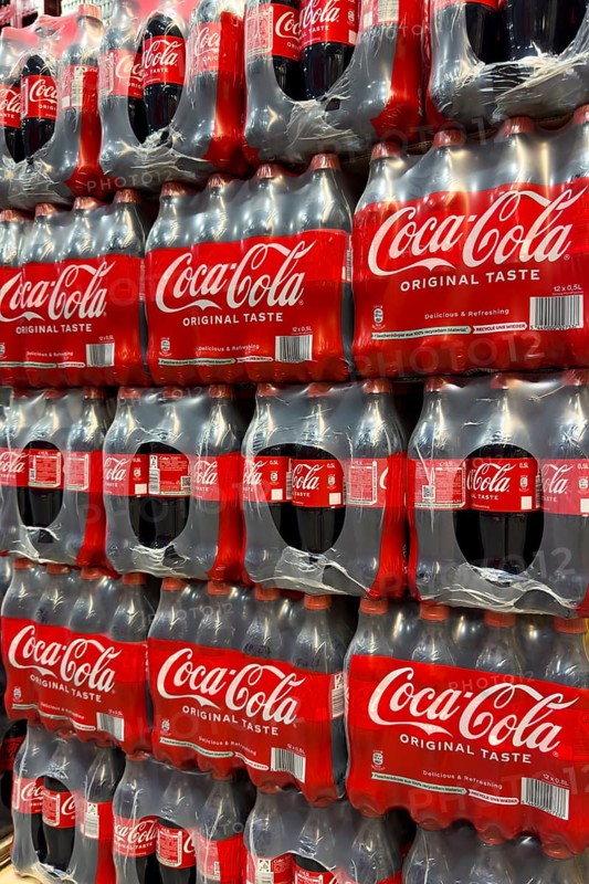 0.5 half liter plastic PET bottles stacked in plastic packs with sugary caffeinated beverage soft drink Coca Cola, Germany