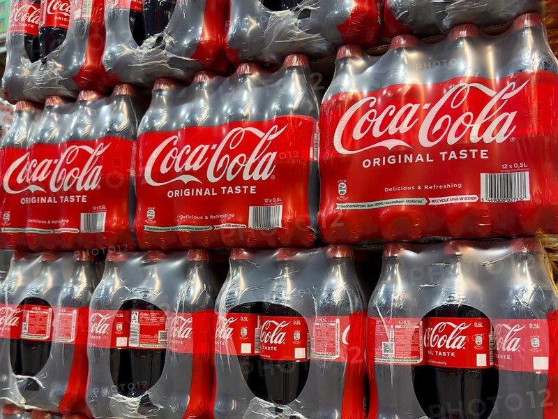 0.5 half liter plastic PET bottles stacked in plastic packs with sugary caffeinated beverage soft drink Coca Cola, Germany