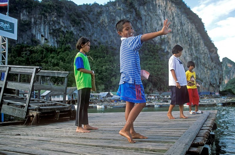 Children, little boy waving in the stilt village of Ko Pannyi in Phangnga Bay near Ko Phuket, two years in front of the tsunami, Thailand, December 2002, vintage, retro, old, historic