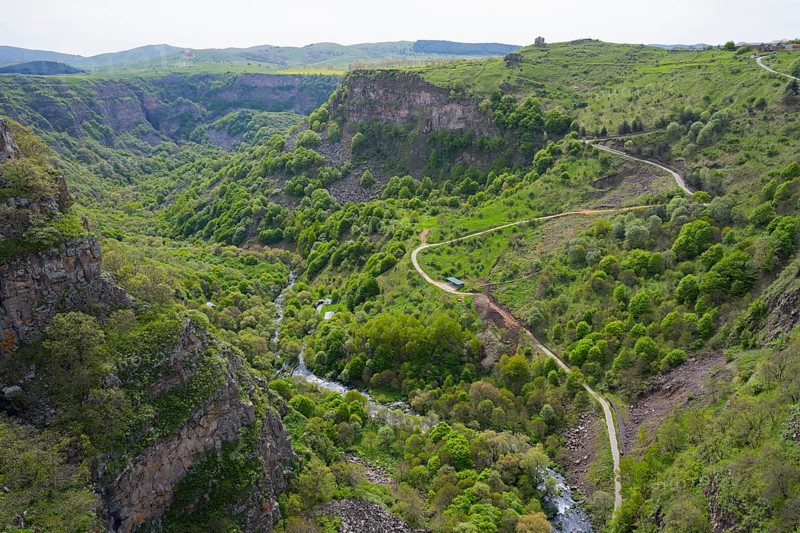 Lush green gorge with winding paths along which a river flows, surrounded by mountains, Dashbashi Gorge, Khrami River, Tsalka Nature Reserve, Kartli, Georgia