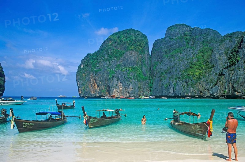 People, longtail boats on Maya Bay beach, known from the movie The Beach, one year in front of the tsunami, Ko Phi Phi Le, Thailand, December 2002, vintage, retro, old, historic