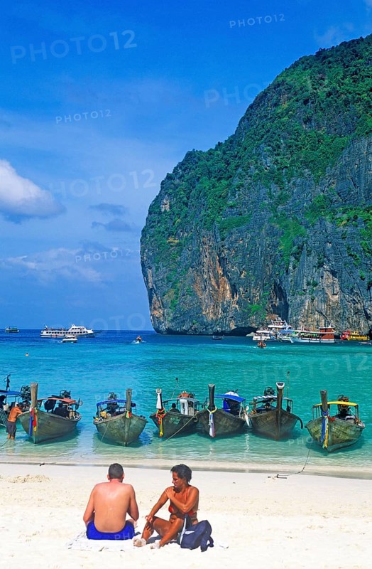 People, longtail boats on Maya Bay beach, known from the movie The Beach, one year in front of the tsunami, Ko Phi Phi Le, Thailand, December 2002, vintage, retro, old, historic