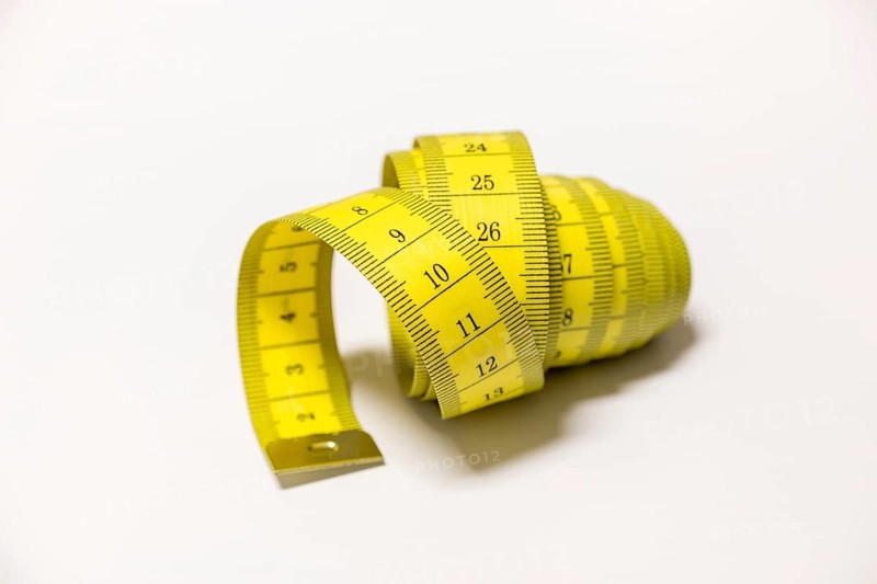 Yellow tape measure rolled into a spiral shape, Germany