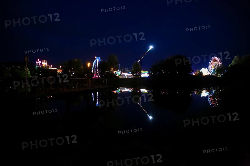 Fairground in Ulm Friedrichsau at night, folk festival, hustle and bustle, fair, Ferris wheel, amusement park, amusement attraction, ride, artificial light, darkness, reflection in natural lake, Ausee, Ferris wheel, Ulm, Baden-Württemberg, Germany