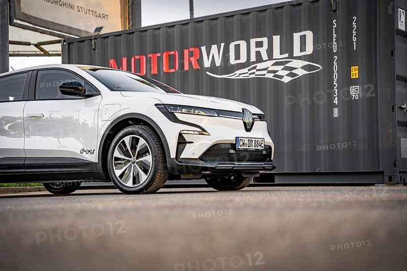 White electric car in front of a black container with Motorworld logo, Deer e-Carsharing, Renault Megane, Calw, Germany