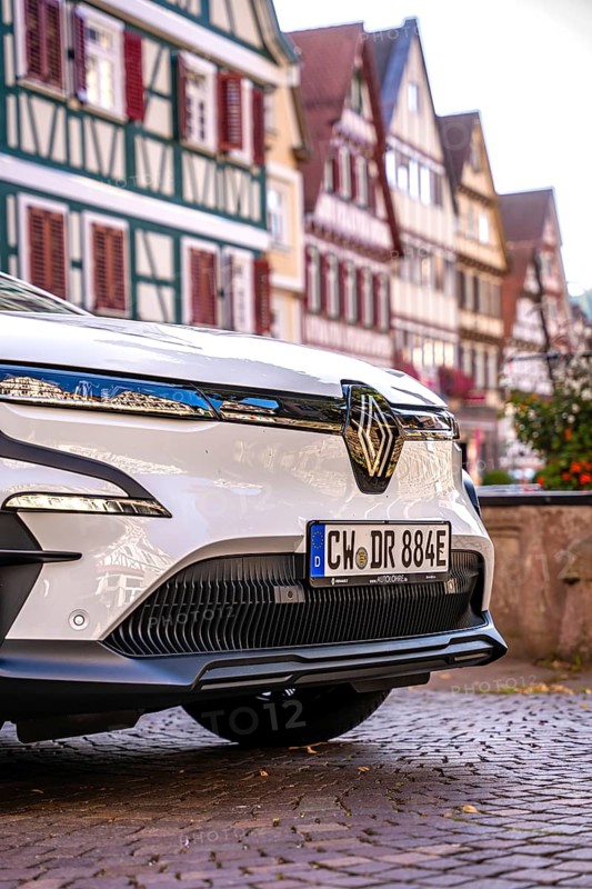 Close-up of a white car with frame houses reflecting on the body, Deer E-Carsharing, Renault Megane, Calw, Germany