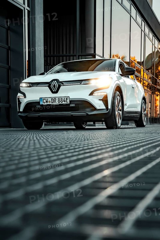Renault car in front of reflecting windows at sunset in urban environment, Deer e-car sharing, Renault Megane, Calw, Germany