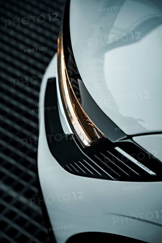 Close-up of a white car focusing on the modern headlight design, Deer E-Carsharing, Renault Megane, Calw, Germany