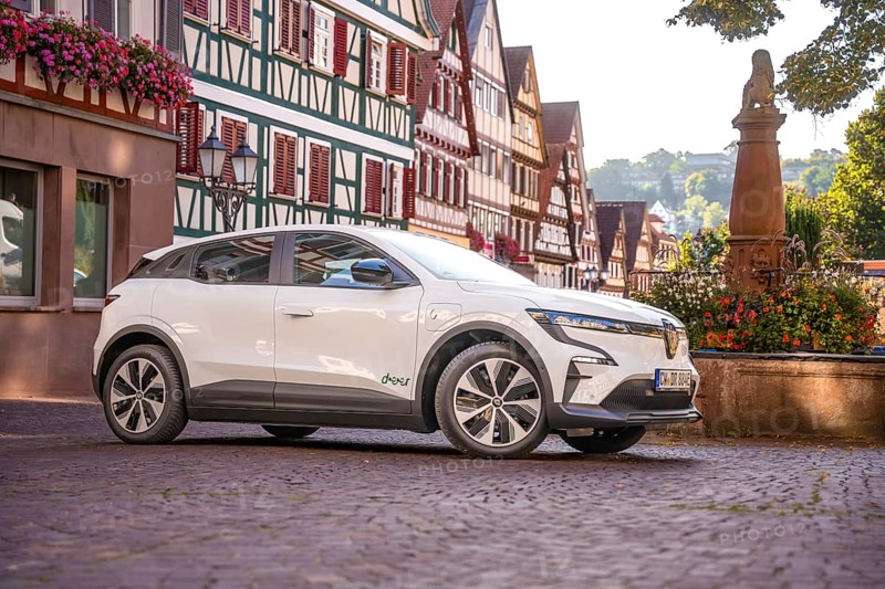 Side view of white car in a historic town with half-timbered houses in summer, Deer e-car sharing, Renault Megane, Calw, Germany