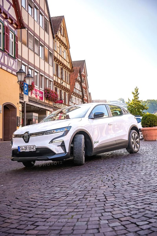 Renault Auto drives down the paved street of a historic town, Deer e-Carsharing, Renault Megane, Calw, Germany