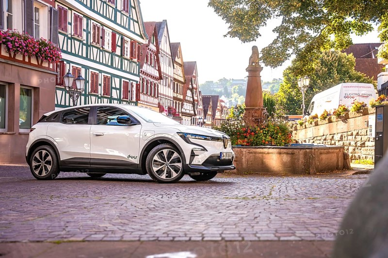 White car next to a statue in a charming half-timbered old town, Deer e-car sharing, Renault Megane, Calw, Germany