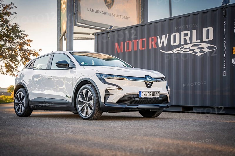 A white electric car stands in front of a Motorworld container with good lighting, Deer e-Carsharing, Renault Megane, Calw, Germany