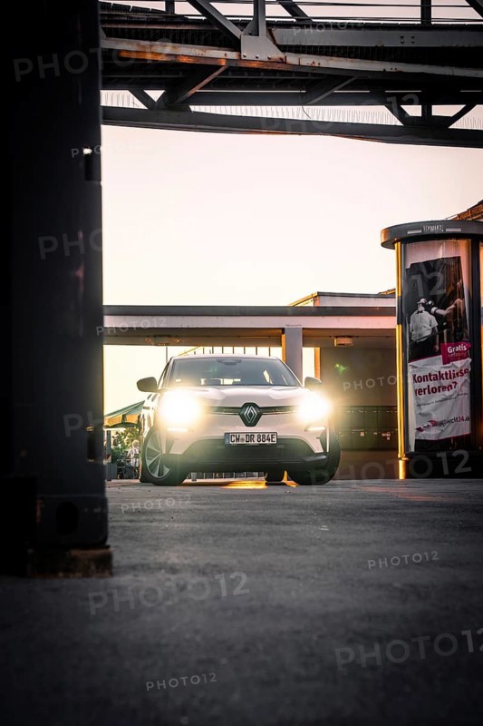 Car in evening lighting on an urban sidewalk surrounded by lanterns, Deer E-Carsharing, Renault Megane, Calw, Germany