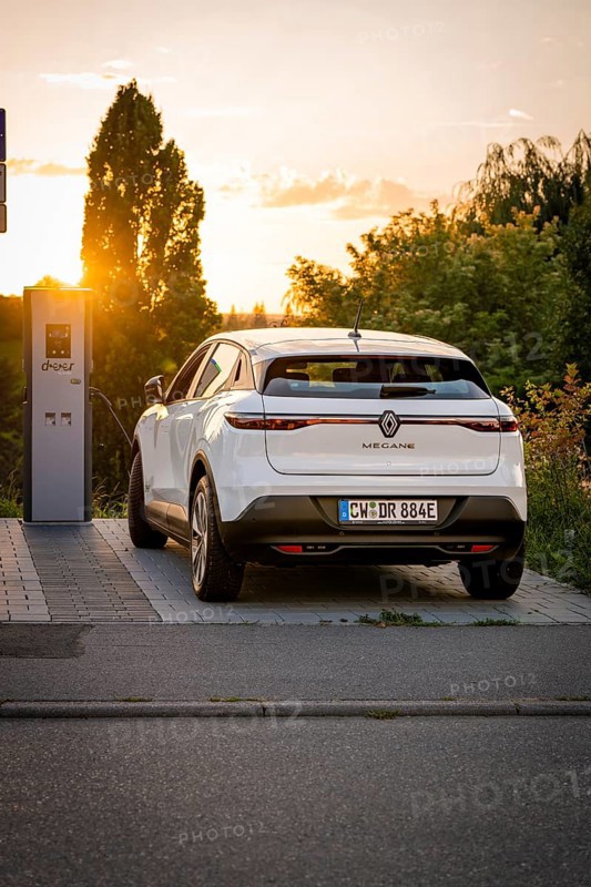 A car charges at a station, illuminated by the warm shade of sunset, Deer E-Carsharing, Renault Megane, Calw, Germany