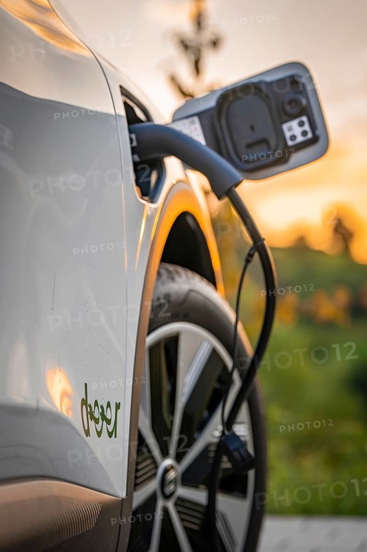 Electric car is charged at a charging station during autumn sunset, Deer e-Carsharing, Renault Megane, Calw, Germany