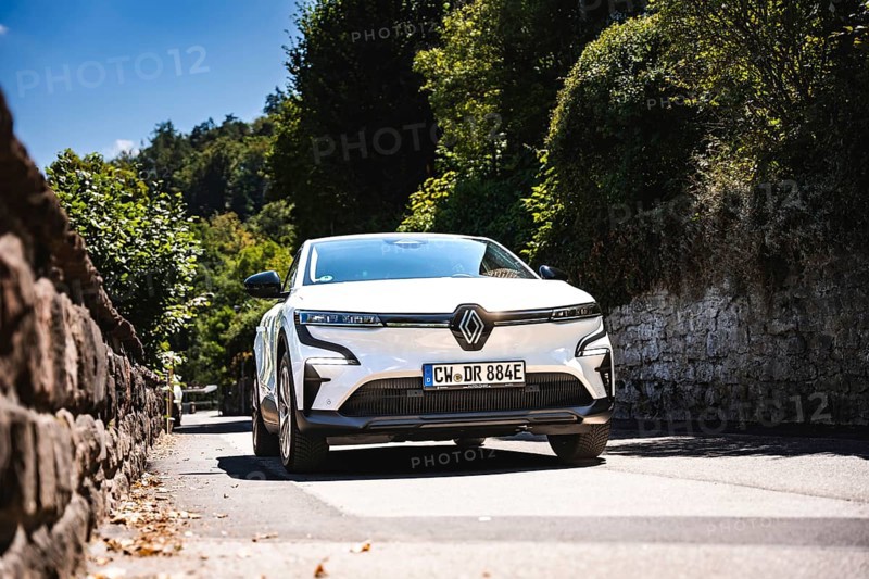 White car driving down a tree-lined stone road, Deer E-Carsharing, Renault Megane, Calw, Germany