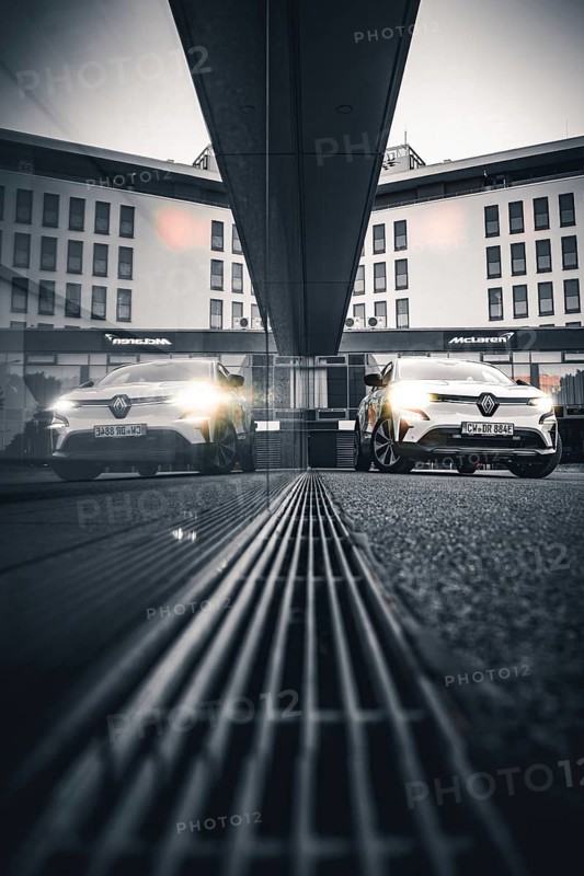 Car reflected in a modern building at gray dusk, Deer E-Carsharing, Renault Megane, Calw, Germany
