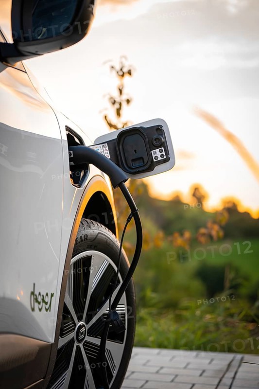 Electric car is charged at a charging station at sunset, Deer e-Carsharing, Renault Megane, Calw, Germany