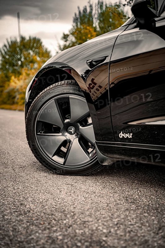 Detailed view of a car tire on a grey road surface, Deer e-car sharing, Tesla Model 3, Calw, Germany