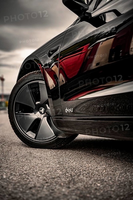 Close-up of a car tire on asphalt, reflective surface, Deer e-car sharing, Tesla Model 3, Calw, Germany