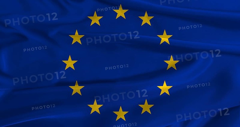 Flag of the European Union with fabric textured background. Close up of National flag of the European Union with realistic texture