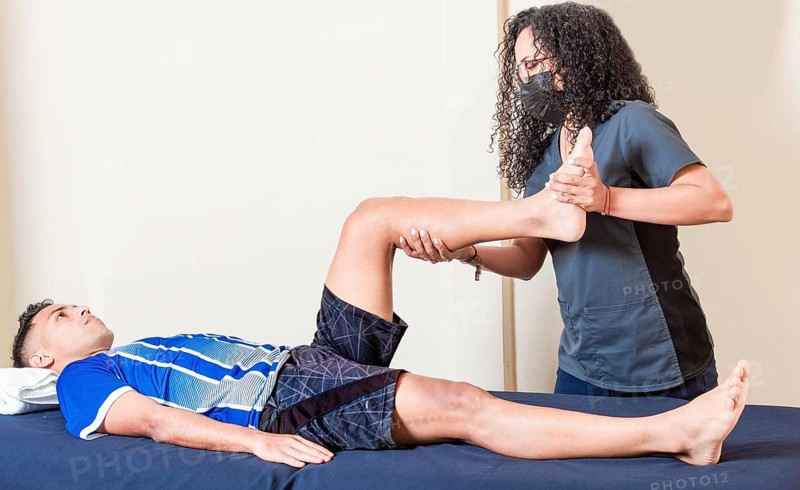 Physiotherapist checking patient leg. Orthopedic specialist helping a patient with a leg injury. physiotherapy treatment concept, Leg rehabilitation physiotherapy