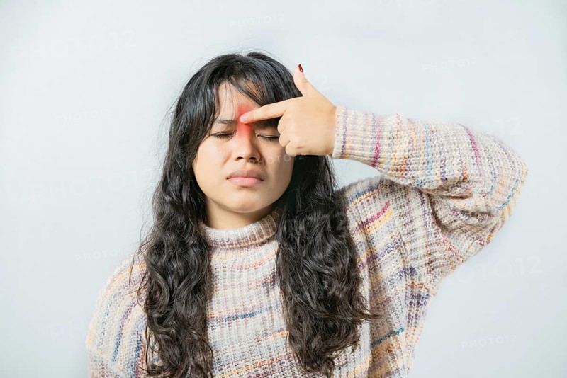 Asian woman with nasal bridge pain isolated. Girl with nasal bridge ache isolated