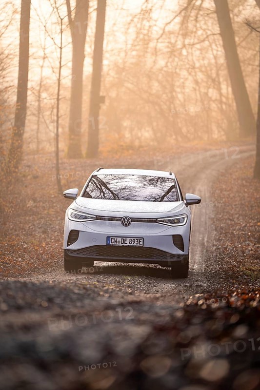 An SUV on a curvy forest path at dawn, Deer E-Carsharing, VW ID4, Calw, Germany