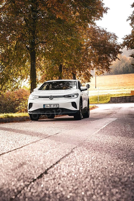 SUV on a barely traveled road, surrounded by autumn trees, deer e-car sharing, VW ID4, Calw, Germany