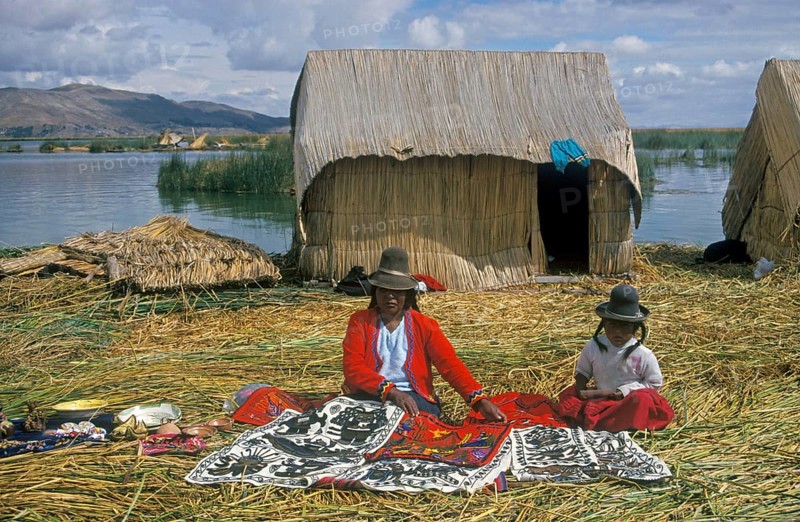 Mother and little daughter sell souvenirs on a floating Uro island in Lake Titcaca, Andean highlands near Puno, South America, September 1997, vintage, retro, old, historic