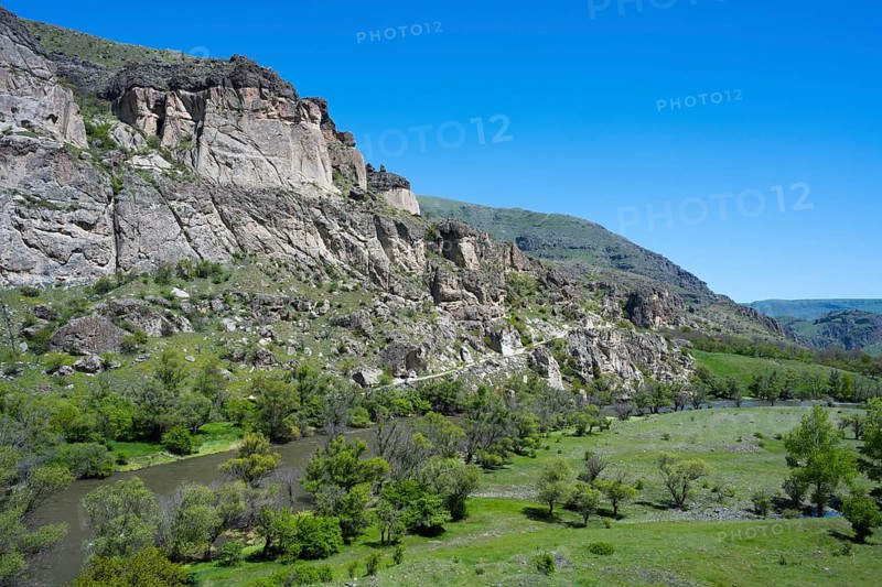 A river flows through a green valley with rocky slopes and trees, Kura River, landscape near Vardzia, Samtskhe—Javakheti region, Samtske Javacheti, Lesser Caucasus, Georgia