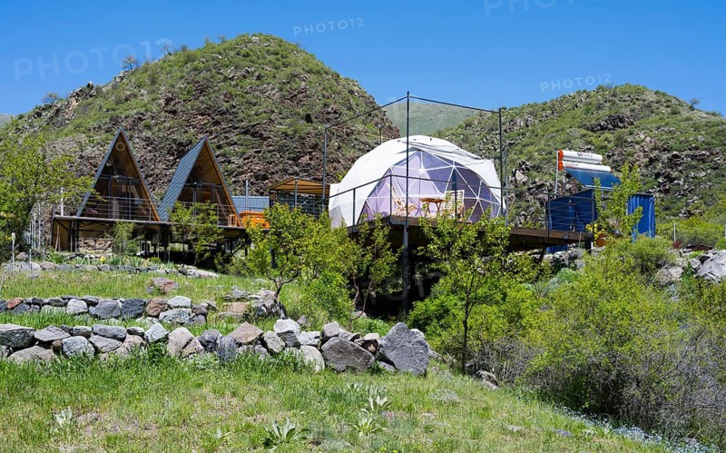 Campsite with huts and tents nestled in rolling green countryside, Vardzia Glamping, Vardzia, Samtske-Javakheti region, Samtske Javacheti, Lesser Caucasus, Georgia