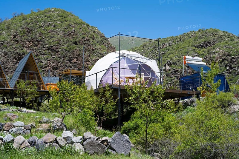 A modern dome tent in a mountainous landscape under blue sky, surrounded by green nature, Vardzia Glamping, Vardzia, Samtskhe—Javakheti region, Samtske Javacheti, Lesser Caucasus, Georgia