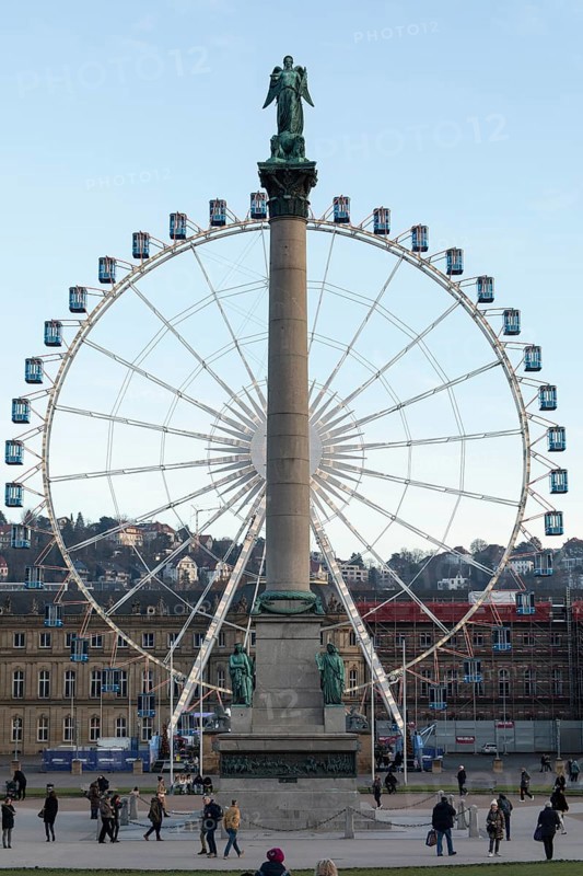 Stuttgart offers a cozy atmosphere in the evening with a view of the illuminated Ferris wheel with the anniversary column in the foreground