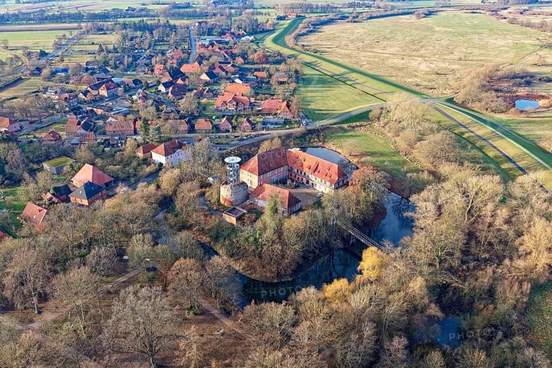 The Elbe Castle Bleckede, a two-wing palace complex and original lowland castle, on a medieval keep in Bleckede in the Lüneburg district of Lower Saxony. aerial view. Bleckede, Lower Saxony, Germany