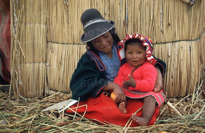 Children sitting in front of a reed hut on a floating Uro island in Lake Titcaca, Peru, South America, September 1997, vintage, retro, old, historic