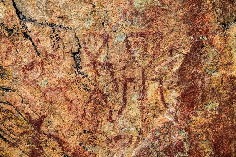 Prehistoric rock rock painting in reddish brown on a textured surface Rock paintings from Värikallio, rock wall above Somerjärvi, Hossa National Park, Suosalmi, Finland