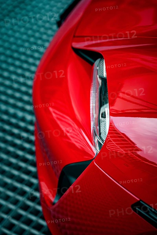 Close-up of the front end of a red Porsche with focus on headlight design, Porsche Taycan, Deer Carsharing, Calw, Germany