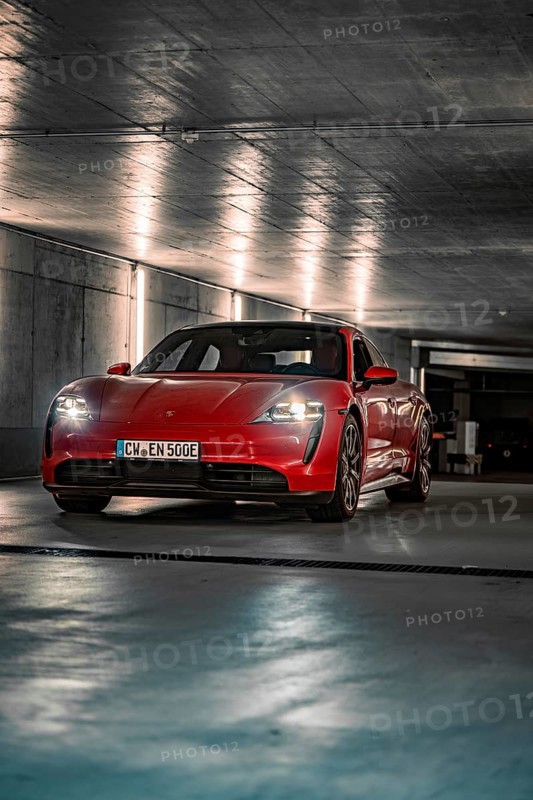 Red Porsche Taycan parked in an illuminated underground car park with an urban atmosphere, Porsche Taycan, Deer Carsharing, Calw, Germany